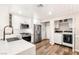 Bright kitchen with white cabinets, stainless steel appliances, island and built in laundry closet at 1125 Lumina Ct, Las Vegas, NV 89117