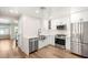 Renovated kitchen features stainless steel appliances, white cabinetry and modern finishes at 1125 Lumina Ct, Las Vegas, NV 89117