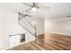 Open living room featuring wood floors, ceiling fan, staircase with modern railing and bonus storage under stairs at 1125 Lumina Ct, Las Vegas, NV 89117
