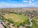 Aerial view of community park with soccer fields, playground, walking paths and lush green landscaping at 12415 Notch Trail Ave, Las Vegas, NV 89138