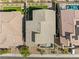 Aerial view of a home showcasing a well-maintained roof and backyard with a pool amidst a neighborhood setting at 12415 Notch Trail Ave, Las Vegas, NV 89138