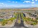 Panoramic aerial view of a Primary-planned community surrounded by mountains at 12415 Notch Trail Ave, Las Vegas, NV 89138