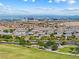 This aerial showcases a neighborhood park with green spaces, walking paths, and a city skyline backdrop at 12415 Notch Trail Ave, Las Vegas, NV 89138