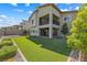 Expansive backyard with artificial turf, trees, and a covered patio perfect for outdoor activities and entertaining at 12415 Notch Trail Ave, Las Vegas, NV 89138