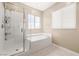 Clean bathroom showcasing a tub and shower with white tiled walls at 12415 Notch Trail Ave, Las Vegas, NV 89138