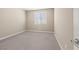 Neutral bedroom with carpeted floors and a window providing natural light at 12415 Notch Trail Ave, Las Vegas, NV 89138