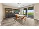Elegant dining area with hardwood floors, stylish furniture, and sliding glass door to the outdoor patio at 12415 Notch Trail Ave, Las Vegas, NV 89138