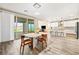 Open-concept dining area adjacent to the modern kitchen with stylish table and access to the outdoor patio at 12415 Notch Trail Ave, Las Vegas, NV 89138
