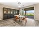 Elegant dining area with hardwood floors, stylish furniture, and sliding glass door to the outdoor patio at 12415 Notch Trail Ave, Las Vegas, NV 89138