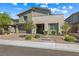 Two-story home with a brick driveway and desert landscaping at 12415 Notch Trail Ave, Las Vegas, NV 89138