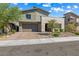 Two-story home featuring desert landscaping, a two-car garage, and a stylish exterior at 12415 Notch Trail Ave, Las Vegas, NV 89138