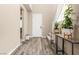 Bright foyer with wood floors, a staircase, and a stylish console table with plants at 12415 Notch Trail Ave, Las Vegas, NV 89138