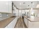 Bright kitchen features a tile backsplash, stainless steel appliances and eat-in counter at 12415 Notch Trail Ave, Las Vegas, NV 89138