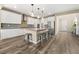 Modern kitchen features white cabinetry, stainless steel appliances, and an island with barstool seating at 12415 Notch Trail Ave, Las Vegas, NV 89138