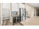 Kitchen boasts stainless steel refrigerator, custom cabinets, and a beverage cooler at 12415 Notch Trail Ave, Las Vegas, NV 89138