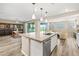 Open-concept kitchen with stainless appliances, large island, and seamless flow into dining and living areas at 12415 Notch Trail Ave, Las Vegas, NV 89138