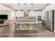 Open-concept kitchen featuring a center island with bar stools, stainless appliances, and sleek cabinetry at 12415 Notch Trail Ave, Las Vegas, NV 89138