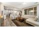 Bright and airy living room featuring hardwood floors, modern furniture, and a sliding glass door at 12415 Notch Trail Ave, Las Vegas, NV 89138