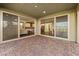 Covered patio featuring brick flooring, a view into an open-concept living space, and a seamless indoor/outdoor connection at 12415 Notch Trail Ave, Las Vegas, NV 89138