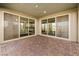Covered patio with brick flooring featuring sliding glass doors that open to a bright interior space at 12415 Notch Trail Ave, Las Vegas, NV 89138