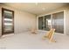 Outdoor patio with two wooden chairs, perfect for enjoying the weather at 12415 Notch Trail Ave, Las Vegas, NV 89138