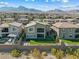 Home's rear exterior features a modern design, a small balcony, a fenced yard, and mountain views at 12415 Notch Trail Ave, Las Vegas, NV 89138
