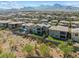 The backyard of this home features a patio with pool, modern landscaping, and mountain views at 12415 Notch Trail Ave, Las Vegas, NV 89138