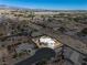 Real estate shot featuring an aerial view of house with a backyard pool and desert landscape at 231 Bristle Cone, Pahrump, NV 89048