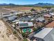 A lovely aerial shot of a single Gathering home with a pool, desert landscape, and mountain views at 231 Bristle Cone, Pahrump, NV 89048
