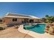 Backyard pool with waterfall, a spa, and mature landscaping create a peaceful retreat at 231 Bristle Cone, Pahrump, NV 89048