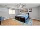 Comfortable bedroom with a ceiling fan, decorative art, and a large window at 231 Bristle Cone, Pahrump, NV 89048