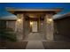 Inviting front entrance with stone pillars, custom door, and desert landscaping at 231 Bristle Cone, Pahrump, NV 89048