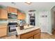 Well-equipped kitchen featuring stainless steel appliances and granite countertop island at 231 Bristle Cone, Pahrump, NV 89048