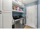 Bright laundry room featuring a washer, dryer, built-in shelves and plenty of storage space at 231 Bristle Cone, Pahrump, NV 89048