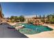 Inviting backyard pool and spa with rock waterfall, offering a tranquil oasis at 231 Bristle Cone, Pahrump, NV 89048