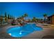 Luxurious pool with a cascading rock waterfall and spa offers a resort-like experience at 231 Bristle Cone, Pahrump, NV 89048