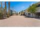Wide view of the backyard featuring gravel, trees, shrubbery, and a light-colored exterior at 2724 Natalie Ave, Las Vegas, NV 89121