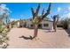 Large gravel backyard featuring mature landscaping, with trees and shrubbery along the fence line at 2724 Natalie Ave, Las Vegas, NV 89121