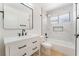 Modern bathroom featuring a white vanity, marble tile, and shower with black hardware at 2724 Natalie Ave, Las Vegas, NV 89121