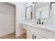 Bathroom featuring white vanity, black hardware, dual mirrors and a closet for storage at 2724 Natalie Ave, Las Vegas, NV 89121