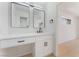 Bright bathroom with white vanity, black hardware, and dual mirrors enhances the home's modern appeal at 2724 Natalie Ave, Las Vegas, NV 89121