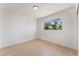 Bright bedroom featuring light wood floors and a window with a lush tree view at 2724 Natalie Ave, Las Vegas, NV 89121