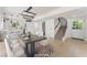 Open-concept dining area with modern light fixture, access to kitchen and a staircase to the second floor at 2724 Natalie Ave, Las Vegas, NV 89121