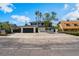 Two-story home with a black roof, black garage door, palm trees and desert landscaping in front at 2724 Natalie Ave, Las Vegas, NV 89121