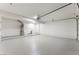 Spacious garage with white walls, painted floor, water heater and overhead door at 2724 Natalie Ave, Las Vegas, NV 89121