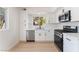 Modern kitchen featuring stainless steel appliances, white cabinets, and a bright window at 2724 Natalie Ave, Las Vegas, NV 89121