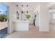 Bright white kitchen featuring a breakfast bar, new stainless steel appliances, and backyard access at 2724 Natalie Ave, Las Vegas, NV 89121