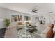 Bright living room featuring neutral furniture, modern ceiling fan, and sliding glass doors to the backyard at 2724 Natalie Ave, Las Vegas, NV 89121