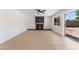 Minimalist living room featuring a fireplace, light wood floors, and sliding glass doors to the backyard at 2724 Natalie Ave, Las Vegas, NV 89121