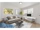 Staged living room with neutral sofa, workspace, and bright natural light at 2724 Natalie Ave, Las Vegas, NV 89121